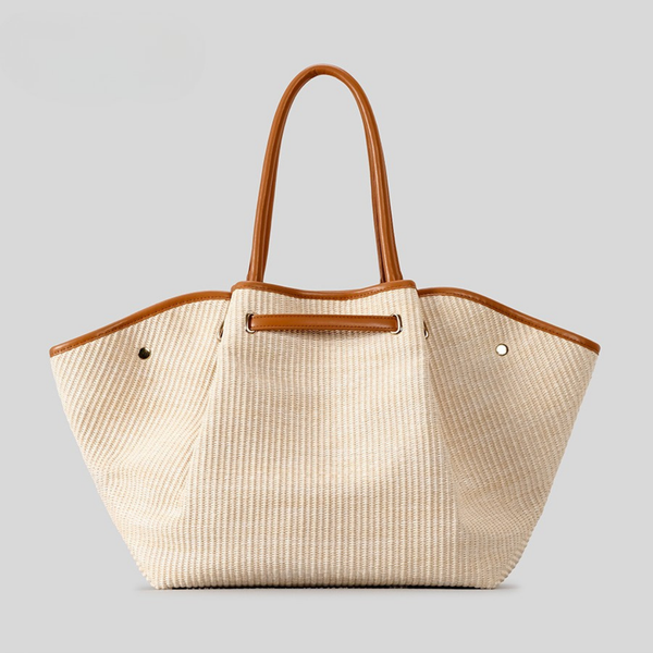 Elysian Winged Straw Tote front view showing winged silhouette and beige woven body