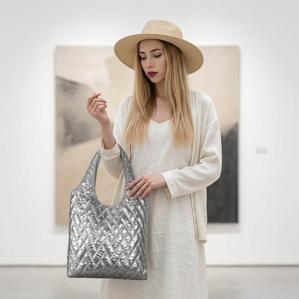 Woman holding a silver quilted handbag in an indoor setting